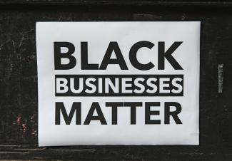 Window sign in a store that reads Black Businesses Matter