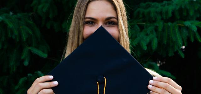 woman covering her face with blue paper by Evan Mach courtesy of Unsplash.